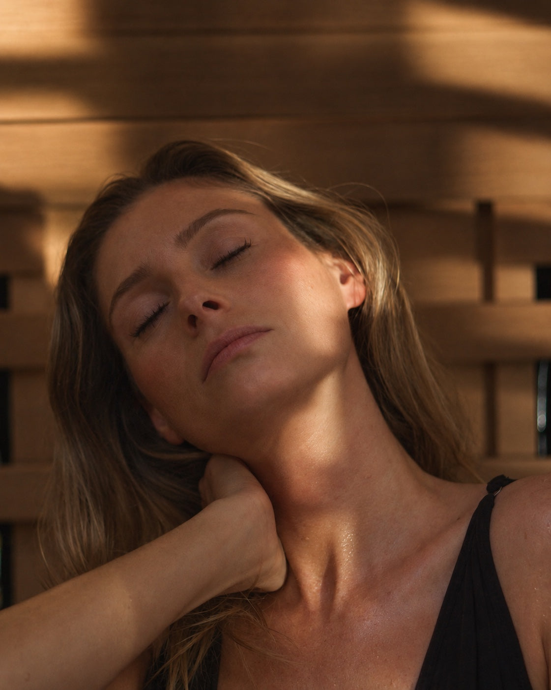 A woman resting inside a PEAK infrared sauna