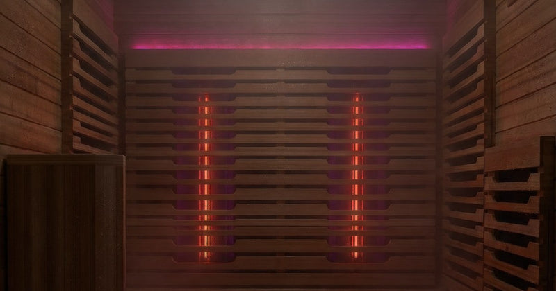 Sauna interior wall with infrared heaters glowing red under a pink light strip