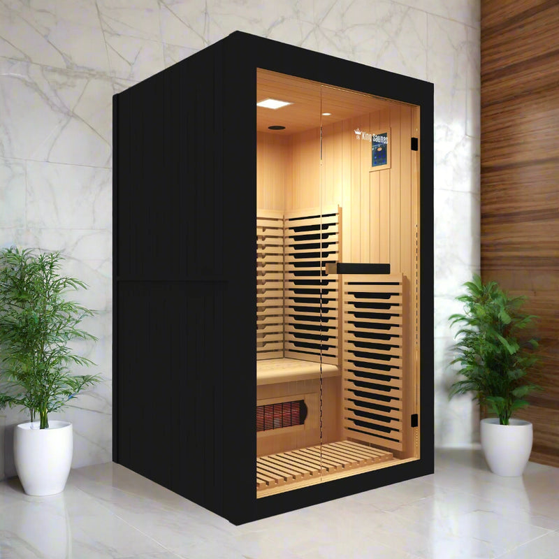 Crown 2-Person Infrared Sauna installed in a modern marble-walled room with potted plants