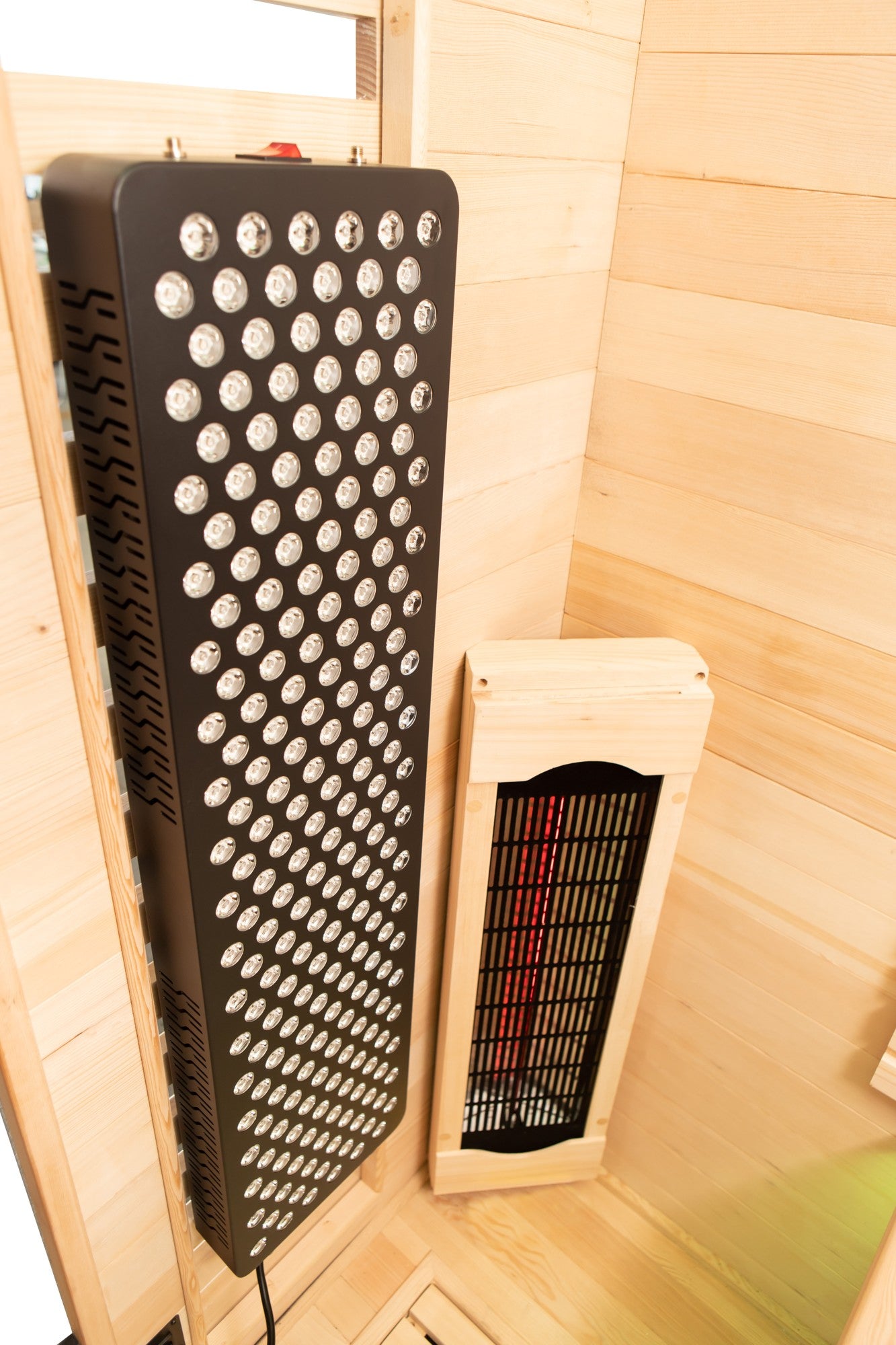 Peak Fuji sauna: Red-light panel beside the heater